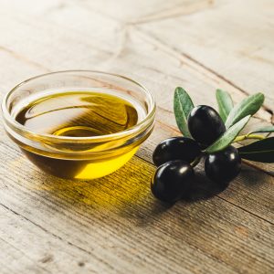 Olive oil with leaves and olives